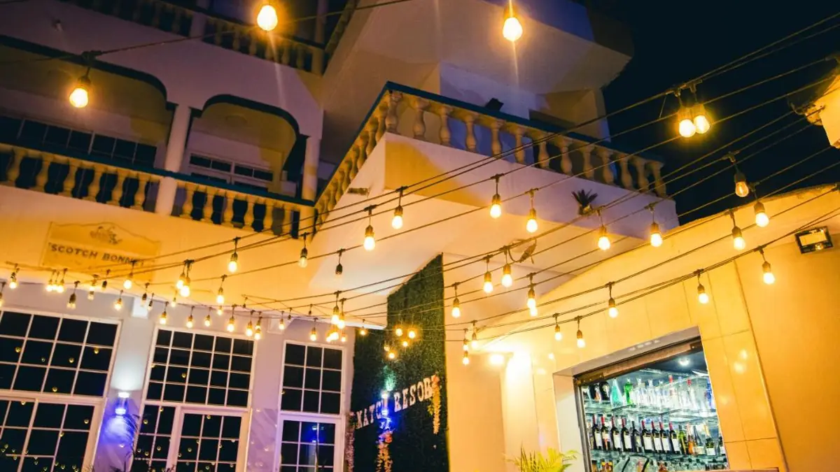 The terrace and bar at The Match Resort at night, with string lights